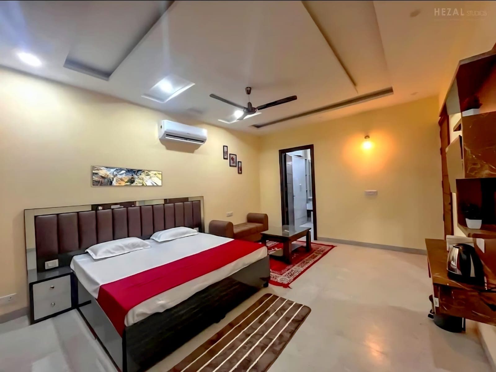 Large air-conditioned bedroom with double bed and sofa at Jastej House, Mohali