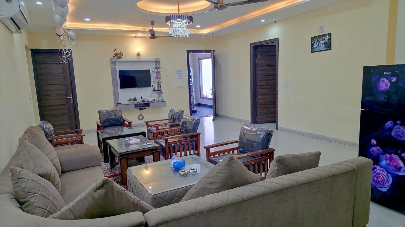 Air-conditioned living hall with sofas and TV at Jastej House